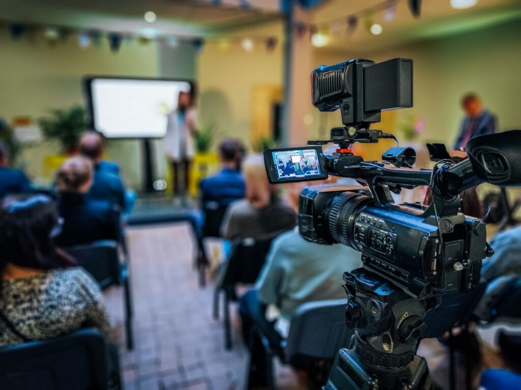 photo of corporate employees attending a live training that is being recorded